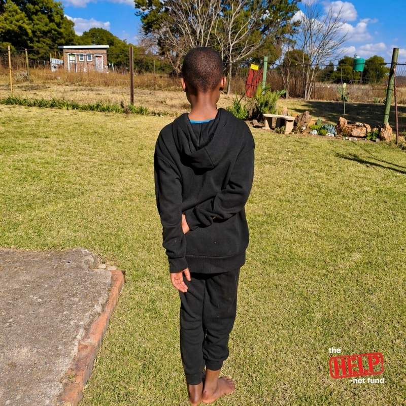A child standing safely outside with room to hope
